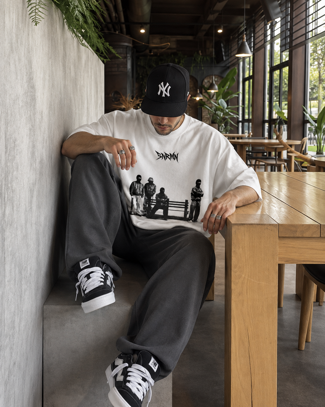 SNRMN white tee seated cafe editorial